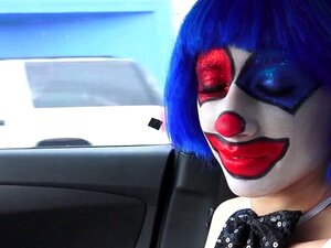 Une mignonne en costume de clown baise en plein air jusqu'à